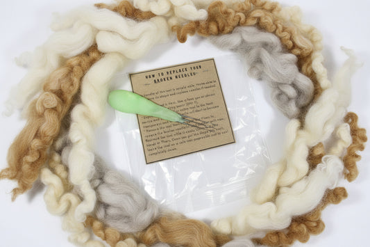 Fishing tool with green handle and needle-like components, wrapped in clear plastic with brown label.