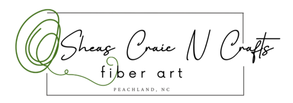 Logo for Sheas Craie N Crafts fiber art with a green abstract design on a white background